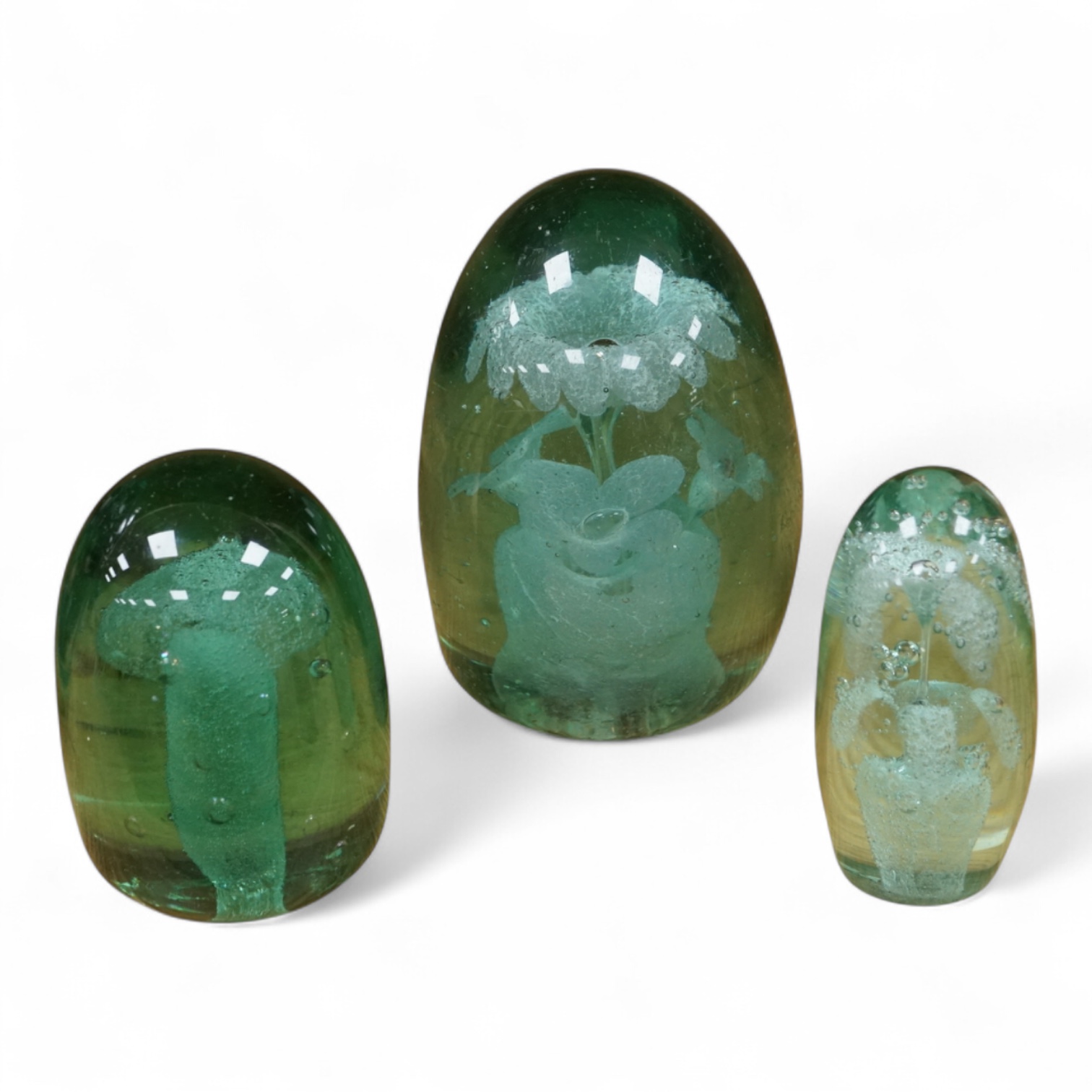 Three Victorian green glass dump weights, largest 14cm high